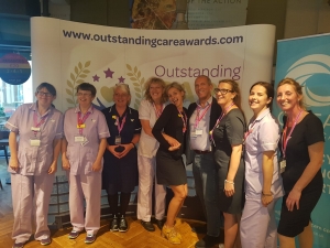 This image shows care staff at an awards event. 